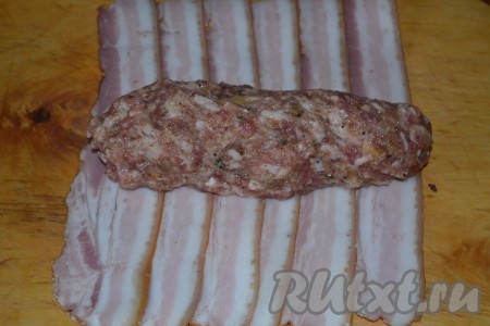 Из фарша формируем колбаски и размещаем на пластиночках бекона.
