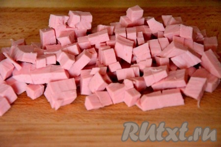 Колбасу нарезать кубиками.