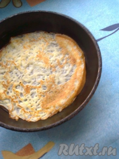 Затем подденьте край блинчика металлической лопаткой или ножом, придержите край рукой и продвиньте лопатку под низ блинчика, переверните.