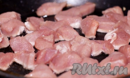 Нарежьте свинину произвольными небольшими кусочками и обжарьте на подсолнечном масле с двух сторон до золотистой корочки на сильном огне.