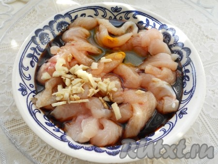 Куриное филе порезать тонкими полосами. Добавить соевый соус и измельченный чеснок, перемешать. Оставить на 15-20 минут.