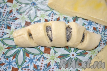 Свернуть рогалик, начиная от узкого края. Шов защипнуть, сделав его внизу рогалика.