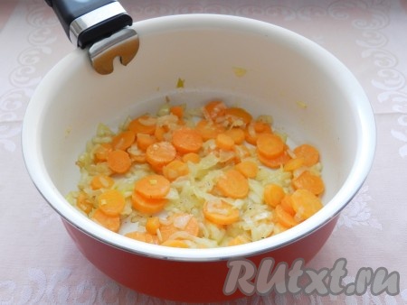 В кастрюле разогреть сливочное масло и обжарить лук до золотистого цвета, посолить и поперчить, затем добавить морковь и немного обжарить все вместе.
