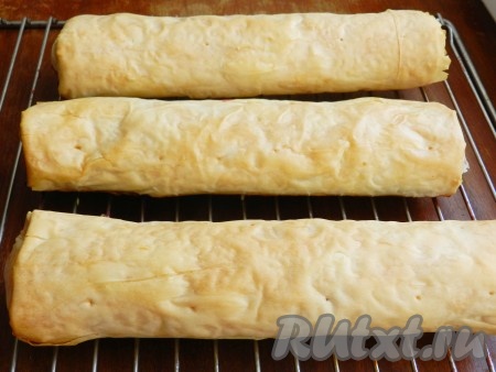 Духовку разогреть до 190 градусов и выпекать рулеты с яблоками в течение 25-30 минут (до золотистого цвета теста фило). Готовые рулеты переложить на решётку, остудить, посыпать сахарной пудрой и подать к столу.