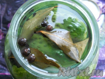 Воду из банки с огурцами и луком снова слить в раковину и сразу залить огурцы кипящим маринадом.