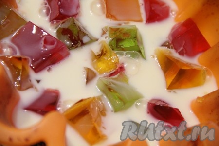 Затем залить цветное желе небольшим количеством молочного желе. Температура молочного желе должна быть слегка тёплой, даже прохладной. Я предварительно ставлю сгущёнку в холодильник, и при смешивании её с желатином смесь уже становится не горячая.
