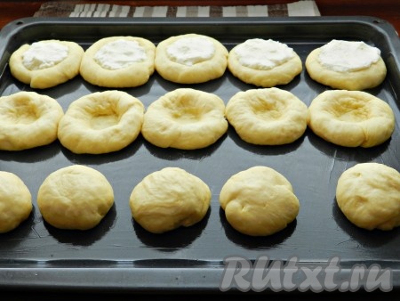 Затем продавить середину каждого шарика теста почти до основания. В получившиеся углубления выложить творожную начинку.