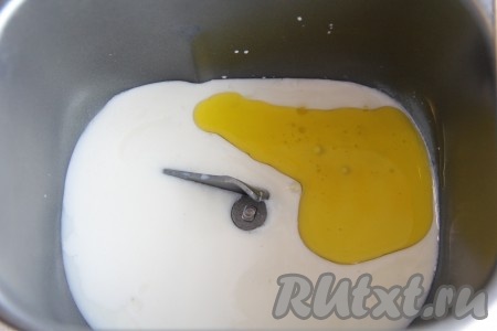 В ведёрко хлебопечки влить тёплое молоко (температура молока должна быть не выше 40 градусов), добавить сахар и растительное масло.