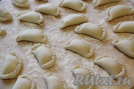 Выложить вареники на поверхность, припорошенную мукой. В таком виде можно заморозить вареники, выложив их на разделочную доску и поместив в морозильную камеру.
