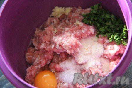 Для формирования фрикаделек можно взять как покупной фарш, так и приготовленный в домашних условиях. Я приготовила фарш, пропустив кусочки свинины через мясорубку. Получившийся фарш переложить в миску. Петрушку вымыть, обсушить и мелко нарезать. Чеснок почистить и пропустить через пресс. К фаршу добавить петрушку, яйцо, манную крупу, чеснок, соль и специи.