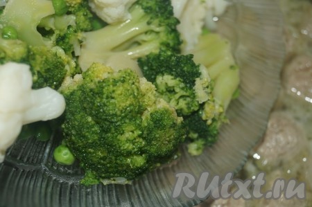 Брокколи и цветную капусту разобрать на соцветия и нарезать, зелёный горошек разморозить, а затем добавить в суп с фрикадельками.
