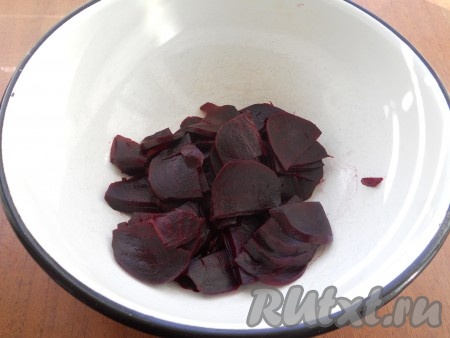 Свеклу хорошо вымыть, залить водой и поставить на огонь, довести до кипения, уменьшить огонь и варить до готовности, примерно 40-50 минут (по желанию свеклу можно запечь в духовке). Остудить, очистить и нарезать свеклу тонкими полукружочками.
