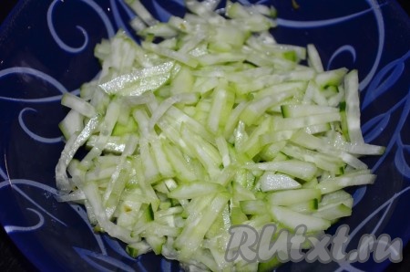 Свежий огурец вымыть, обсушить, по желанию, очистить от кожуры, нарезать его мелкой соломкой, выложить в миску с курицей, овощами и грибами.