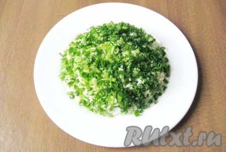 Зеленый лук помыть и мелко нарезать. Выложить следующим слоем салата.

