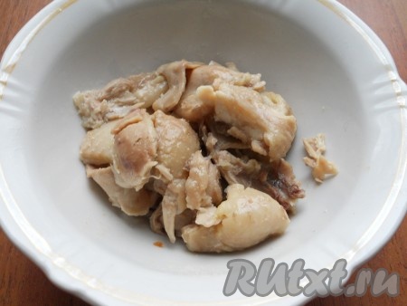 После того как курица сварится, снять кастрюлю с огня, части курицы вынуть из бульона, оставить остывать. Остывшее мясо отделить от костей.