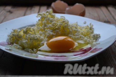 Добавляем к натёртому маслу сахар и сырые яйца.