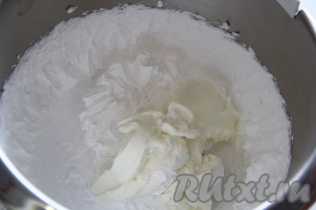 В отдельной ёмкости хорошо охлаждённые сливки взбить миксером до устойчивых пиков, затем добавить к ним творожную массу и перемешать на низких оборотах миксера, чтобы получился однородный чиз крем.&nbsp;