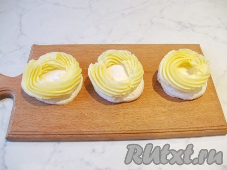 На нижнюю часть пирожного безе с помощью кулинарного мешка отсадить крем.
