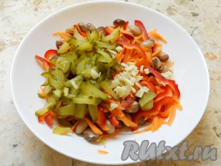 Затем добавить нарезанный соломкой солёный огурец и мелко нарезанный чеснок.