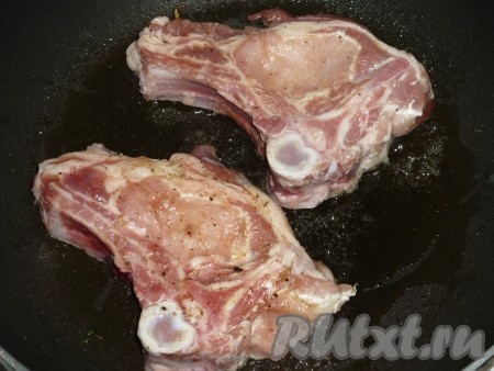 На сковороду влить 2-3 столовых ложки растительного масла и хорошо разогреть. Выложить свиные котлеты на кости на сковороду.