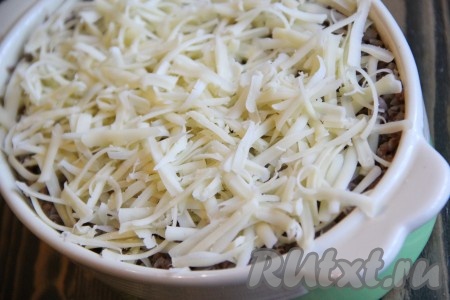 Посыпать запеканку из гречневой каши оставшимся сыром и поставить в разогретую духовку. Готовить при 200 градусах примерно 25 минут. Сыр на запеканке должен зарумяниться.
