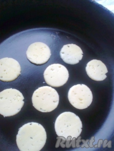 Сухую сковороду нагревать в течение 1 минуты, затем выключить и выложить в нее кружочки сыра, чтобы слегка размягчились.