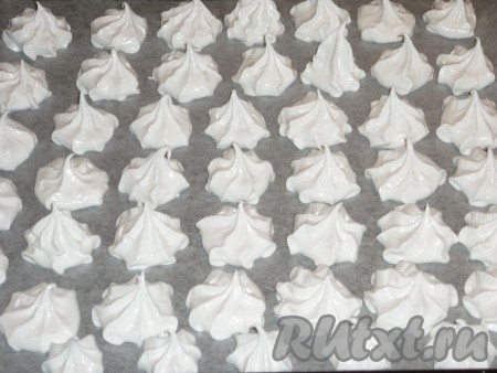 Противень застелить пергаментом. С помощью кондитерского мешка с насадкой отсадить взбитые белки на пергамент на небольшом расстоянии друг от друга. Если нет кондитерского мешка, тогда можно выкладывать белки на пергамент столовой ложки, получится не так красиво, но на вкусе безе это никак не отразится.