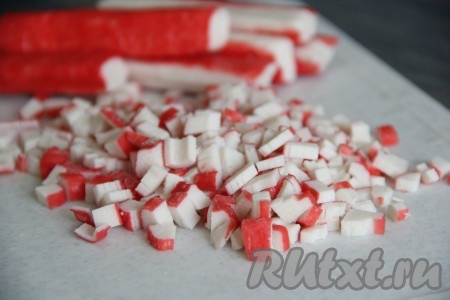 Крабовые палочки очистить от слюды и мелко нарезать.