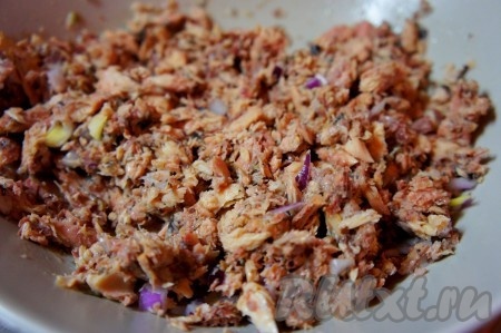 Открыть баночку с консервированной сайрой, лишнее масло слить. Выложить рыбку в тарелку, размять вилкой, а затем добавить нарезанный лук и перемешать.