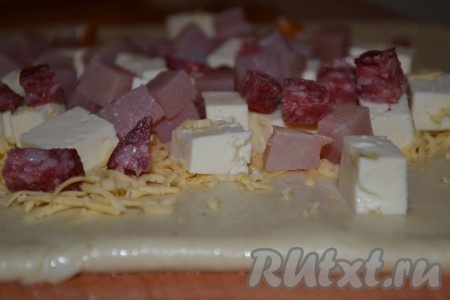 Готовое тесто для пасхального каравая обмять и раскатать в пласт (небольшой кусочек теста оставить для украшения каравая). Сверху выложить сыр. Затем балык и салями. Свернуть пласт в рулет начинкой внутрь и выложить рулет швом вниз в форму для кексов (с дыркой внутри), смазанную маслом.
